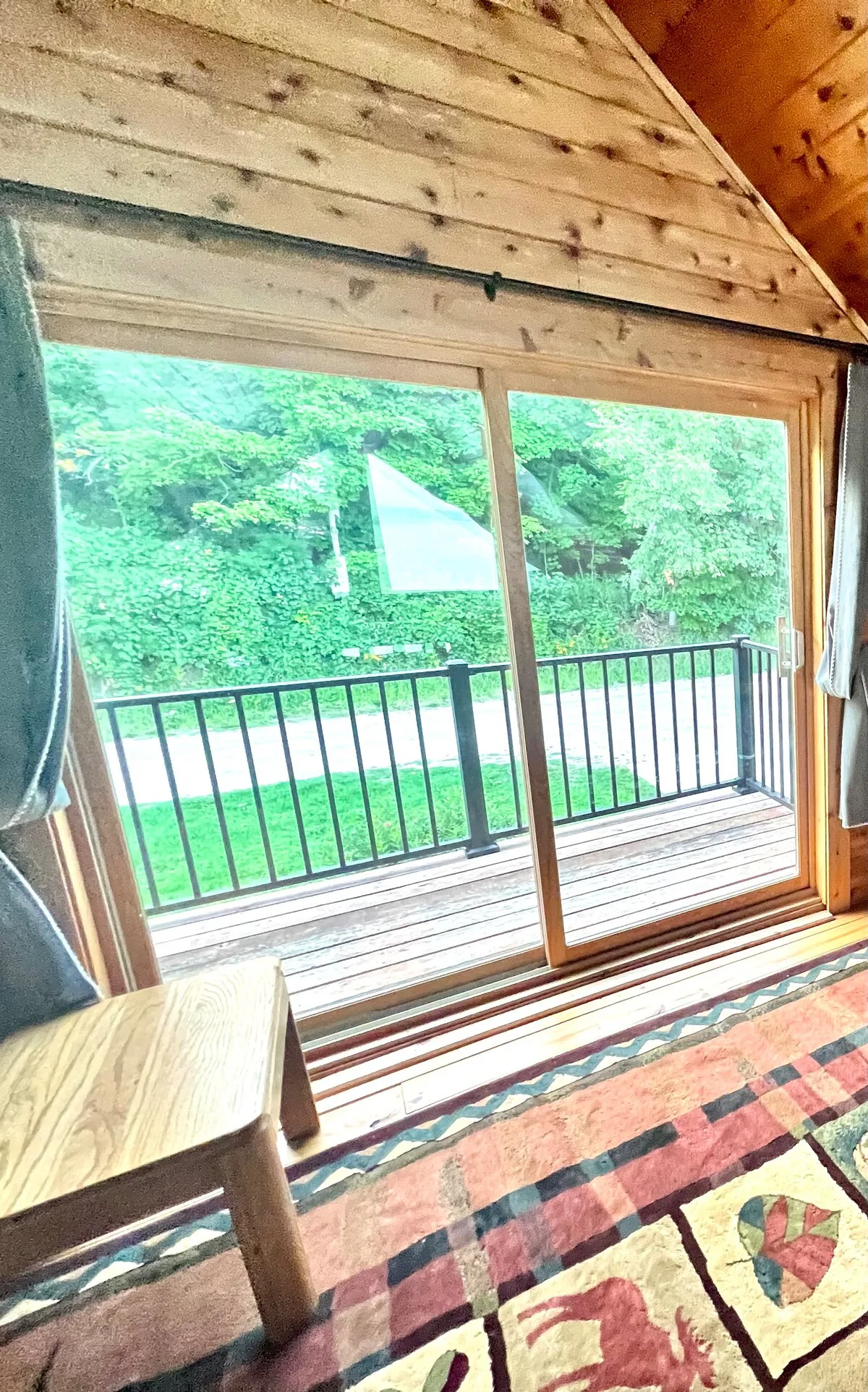 Loft sliding door leading to a private balcony with forest and lake views