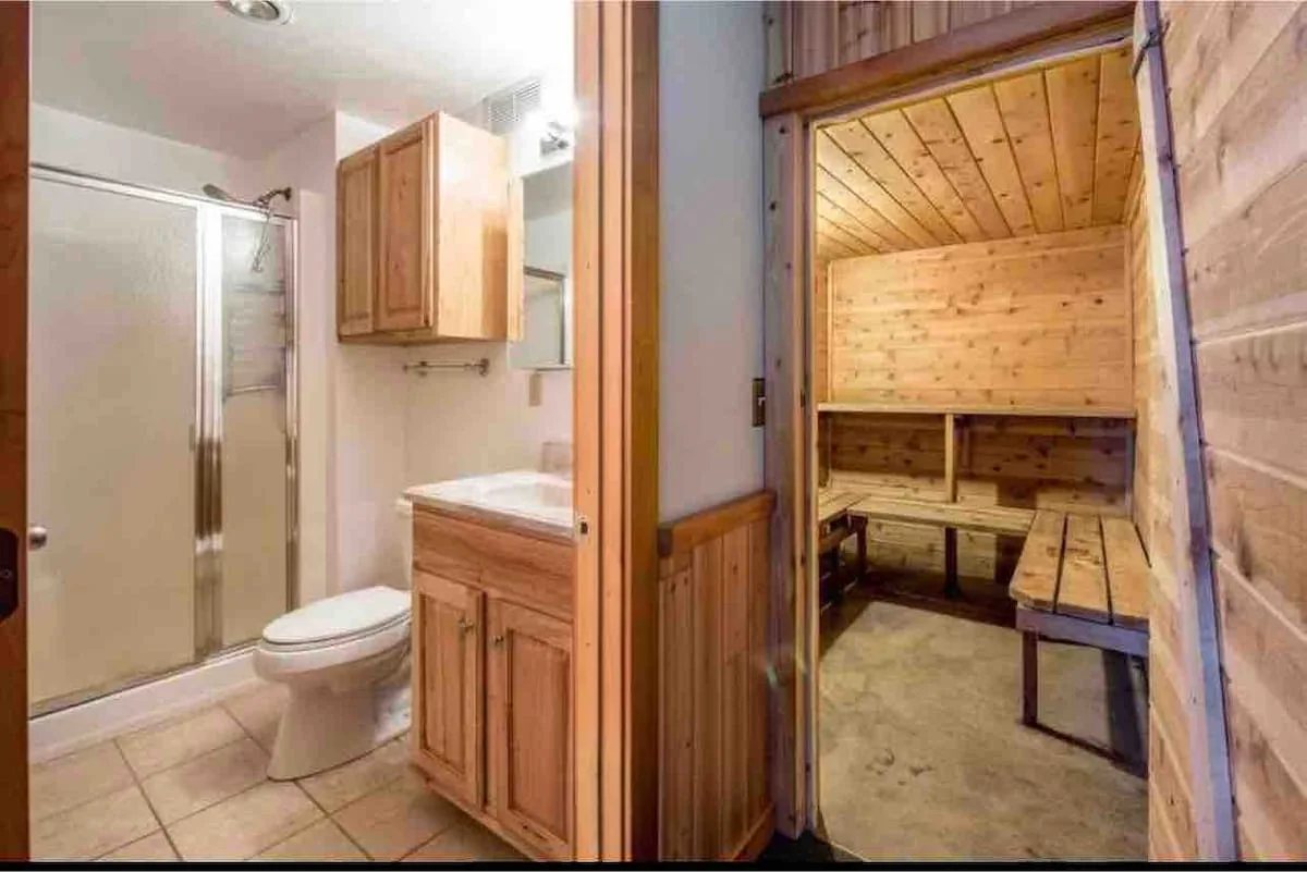 Lower bathroom with view into the cedar-lined sauna room