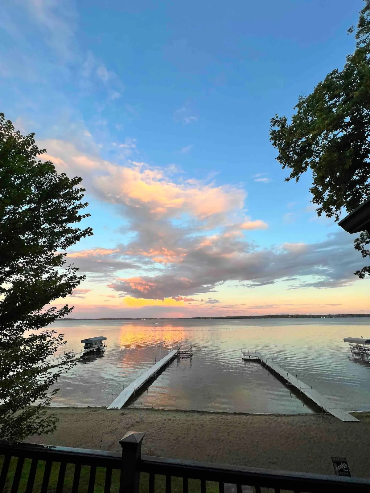 Stunning sunset over Lake Miltona from the upper deck with dock and pontoon boat below